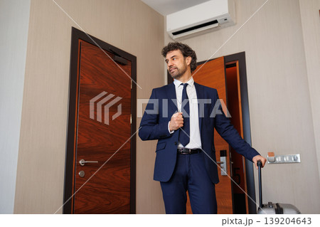 Stylish Business Man In Hotel Room Adjusting Tie After Arrival 139204643