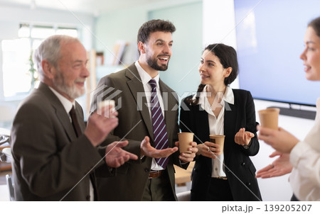 Coffee break - group of office workers drinking coffee and chatting with each other during break 139205207