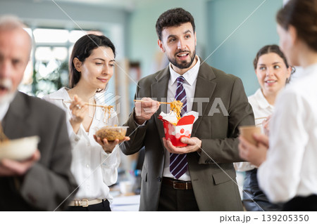 People eat Chinese noodles for lunch People eat Chinese noodles for lunch 139205350