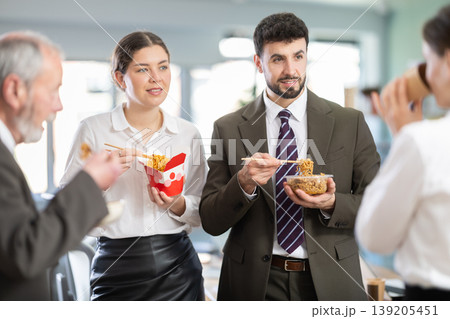 People eat Chinese noodles for lunch People eat Chinese noodles for lunch 139205451