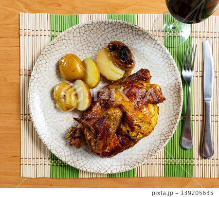 Fried chicken garnished with pieces of baked potatoes Fried chicken garnished with pieces of baked potatoes 139205635