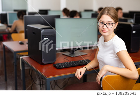 Portrait of interested teen girl during lesson in computer room of school class 139205643