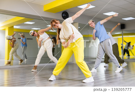 Young girl training breakdance Toprock moves in dance hall Young girl training breakdance Toprock moves in dance hall 139205777