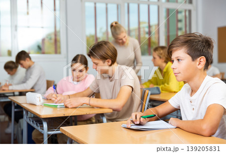Schoolboy posing in classroom during lesson 139205831