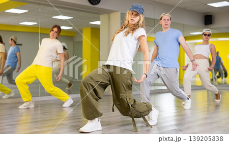 Teen girl in cap dancing modern dances Teen girl in cap dancing modern dances 139205838
