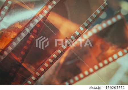 Overlapping film strips with sprocket holes, scratches, and translucent frames, film texture. Concept of analog photography, photo archive, celluloid strip, 35mm film 139205851