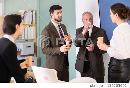 Coffee break - group of office workers drinking coffee and chatting with each other during break 139205991