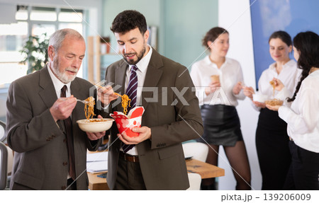 People eat Chinese noodles for lunch People eat Chinese noodles for lunch 139206009