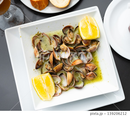Boiled tasty shellfish in their own juice and wine. Spanish cuisine Boiled tasty shellfish in their own juice and wine. Spanish cuisine 139206212
