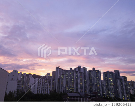 It is a pink sunset and an apartment landscape. It is a pink sunset and an apartment landscape. 139206412