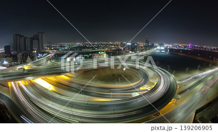 Traffic on a big road junction in Ajman aerial view from rooftop at night timelapse. Traffic on a big road junction in Ajman aerial view from rooftop at night timelapse. 139206905