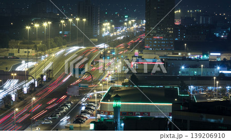 Traffic on a big road junction in Ajman aerial view from rooftop at night timelapse. Traffic on a big road junction in Ajman aerial view from rooftop at night timelapse. 139206910