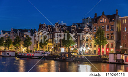Panoramic timelapse hyperlapse of the illuminated famous Dancing Houses along the Amstel River day to night transition. Amsterdam, Netherlands Panoramic timelapse hyperlapse of the illuminated famous Dancing Houses along the Amstel River day to night transition. Amsterdam, Netherlands 139206956