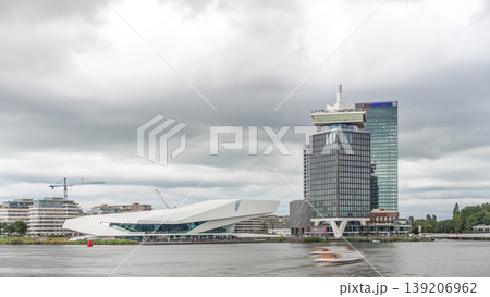 Panoramic view of Amsterdam skyline featuring A'dam Lookout Tower and Eye Film Museum in timelapse. Netherlands Panoramic view of Amsterdam skyline featuring A'dam Lookout Tower and Eye Film Museum in timelapse. Netherlands 139206962