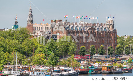 Amsterdam skyline with boats at the pier in Oosterdok harbor with Scheepvaarthuis aerial timelapse. Amsterdam, The Netherlands Amsterdam skyline with boats at the pier in Oosterdok harbor with Scheepvaarthuis aerial timelapse. Amsterdam, The Netherlands 139206979