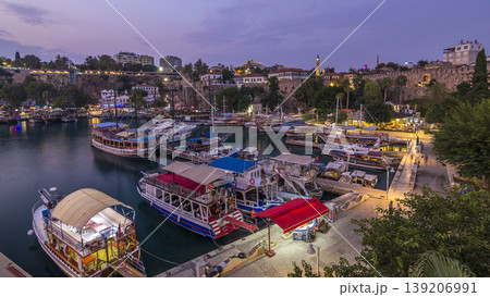 Aerial view of yacht harbor and red house roofs in "Old town" day to night timelapse Antalya, Turkey. 139206991