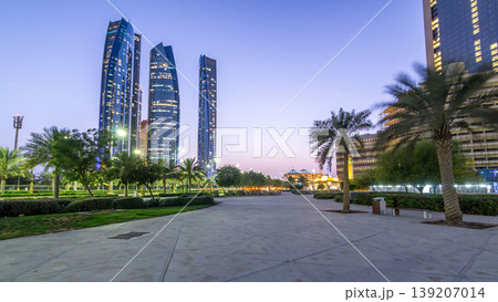 Skyscrapers of Abu Dhabi with Etihad Towers buildings day to night timelapse. Skyscrapers of Abu Dhabi with Etihad Towers buildings day to night timelapse. 139207014