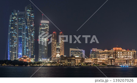 Skyscrapers of Abu Dhabi at night with Etihad Towers buildings timelapse. 139207026