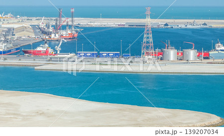Big cargo ship at industrial port timelapse aerial view from above at evening in Abu Dhabi 139207034