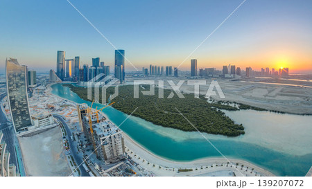 Buildings on Al Reem island in Abu Dhabi at sunset timelapse from above. 139207072