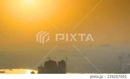 Sunrise with cityscape of Ajman from rooftop aerial timelapse. 139207091