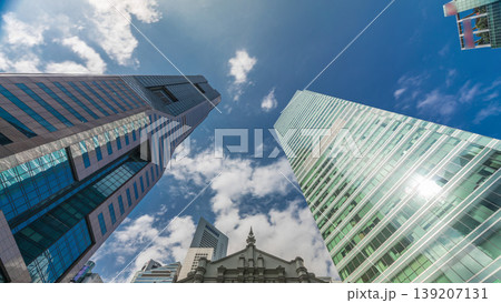 Looking up perspective of modern business skyscrapers glass and sky view landscape of commercial building in central city timelapse Looking up perspective of modern business skyscrapers glass and sky view landscape of commercial building in central city timelapse 139207131