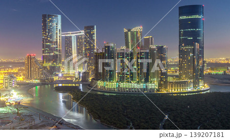 Buildings on Al Reem island in Abu Dhabi day to night timelapse from above. Buildings on Al Reem island in Abu Dhabi day to night timelapse from above. 139207181
