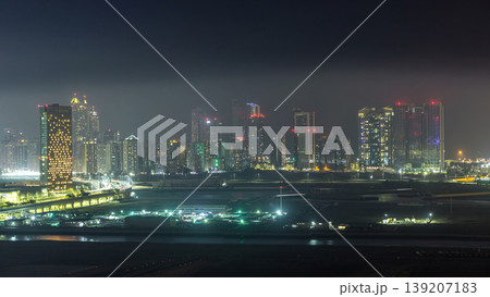 Buildings on Al Reem island in Abu Dhabi night timelapse from above. Buildings on Al Reem island in Abu Dhabi night timelapse from above. 139207183