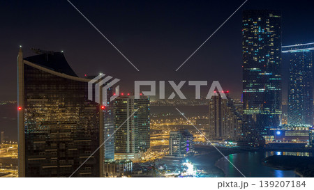 Buildings on Al Reem island in Abu Dhabi night timelapse from above. 139207184