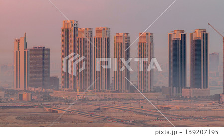 Buildings on Al Reem island in Abu Dhabi night to day timelapse from above. 139207195
