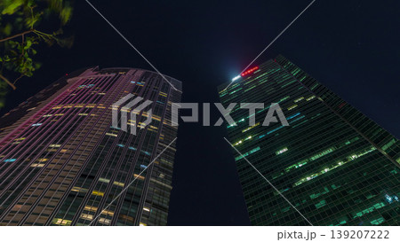 Looking up perspective of modern business skyscrapers glass and sky view landscape of commercial building in central city timelapse Looking up perspective of modern business skyscrapers glass and sky view landscape of commercial building in central city timelapse 139207222