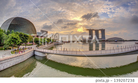 Skyline in Marina Bay with Esplanade Theaters on the Bay and Esplanade footbridge early morning timelapse in Singapore. 139207238