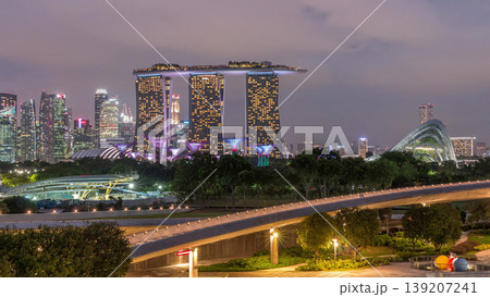 Aerial view after sunset with Singapore city skyline view from Marina barrage garden day to night timelapse. Aerial view after sunset with Singapore city skyline view from Marina barrage garden day to night timelapse. 139207241