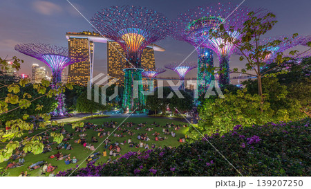Futuristic aerial view of amazing illumination at Garden by the Bay day to night timelapse in Singapore. Futuristic aerial view of amazing illumination at Garden by the Bay day to night timelapse in Singapore. 139207250