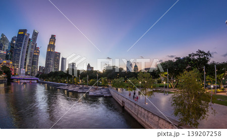 Singapore skyscrapers skyline with white Anderson Bridge near esplanade park day to night timelapse. 139207258