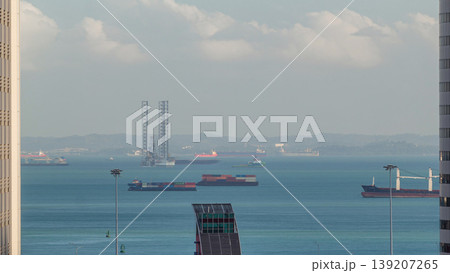 Various cargo ships waiting to load and unload in the harbour near the busiest port of Singapore aerial timelapse Various cargo ships waiting to load and unload in the harbour near the busiest port of Singapore aerial timelapse 139207265