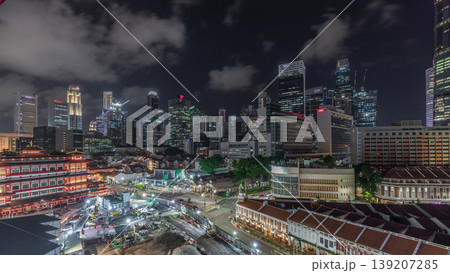 The Buddha Tooth Relic Temple comes alive at night timelapse in Singapore Chinatown, with the city skyline in the background. The Buddha Tooth Relic Temple comes alive at night timelapse in Singapore Chinatown, with the city skyline in the background. 139207285