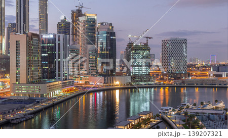 Dubai skyscrapers after sunset near river aerial day to night timelapse Dubai skyscrapers after sunset near river aerial day to night timelapse 139207321