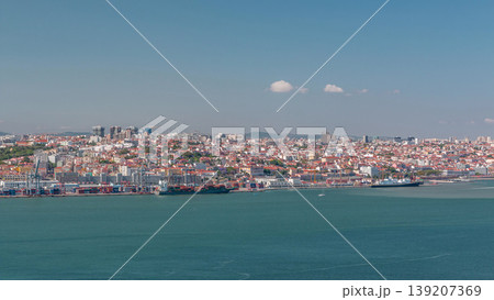 Panorama of Lisbon historical centre aerial timelapse viewed from above the southern margin of the Tagus or Tejo River. 139207369