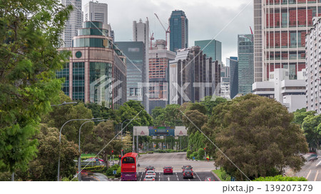 Traffic with cars on a street and urban scene in the central district of Singapore timelapse 139207379