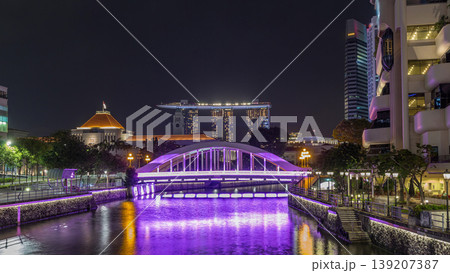 Skyline of Singapore financial district behind Elgin Bridge and the Singapore River night timelapse hyperlapse 139207387
