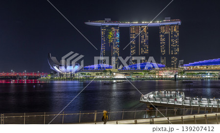 The Merlion fountain spouts water in front of the Marina Bay Sands hotel in Singapore timelapse hyperlapse. The Merlion fountain spouts water in front of the Marina Bay Sands hotel in Singapore timelapse hyperlapse. 139207412