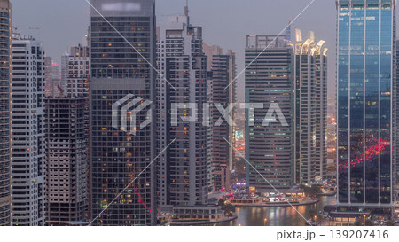 Residential and office buildings in Jumeirah lake towers district day to night timelapse in Dubai Residential and office buildings in Jumeirah lake towers district day to night timelapse in Dubai 139207416