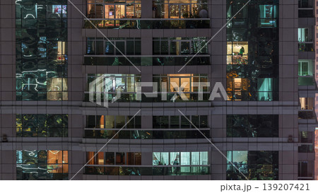 Night view of exterior apartment building timelapse. High rise skyscraper with blinking lights in windows Night view of exterior apartment building timelapse. High rise skyscraper with blinking lights in windows 139207421
