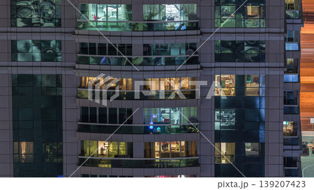 Night view of exterior apartment building timelapse. High rise skyscraper with blinking lights in windows Night view of exterior apartment building timelapse. High rise skyscraper with blinking lights in windows 139207423