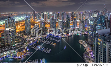 Dubai Marina skyscrapers and jumeirah lake towers view from the top aerial night timelapse in the United Arab Emirates. Dubai Marina skyscrapers and jumeirah lake towers view from the top aerial night timelapse in the United Arab Emirates. 139207486