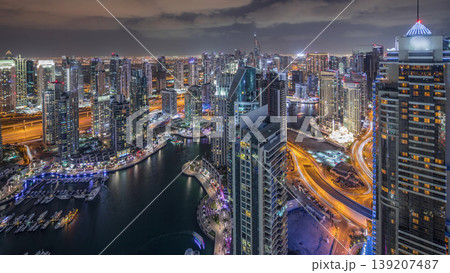 Dubai Marina skyscrapers and jumeirah lake towers view from the top aerial night timelapse in the United Arab Emirates. 139207487