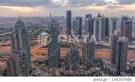Dubai Marina skyscrapers and jumeirah lake towers view from the top aerial night to day timelapse in the United Arab Emirates. Dubai Marina skyscrapers and jumeirah lake towers view from the top aerial night to day timelapse in the United Arab Emirates. 139207489