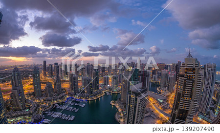 Dubai Marina skyscrapers and jumeirah lake towers view from the top aerial night to day timelapse in the United Arab Emirates. Dubai Marina skyscrapers and jumeirah lake towers view from the top aerial night to day timelapse in the United Arab Emirates. 139207490