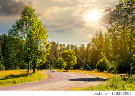 sunset over view of a country road in carpathian mountains for travel. road journey through forested countryside summer scenery. forest on the background hill. sky with clouds and rainbow sunset over view of a country road in carpathian mountains for travel. road journey through forested countryside summer scenery. forest on the background hill. sky with clouds and rainbow 139208005
